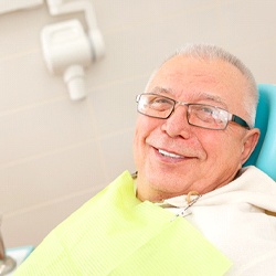 A older man in the dentist chair smiling