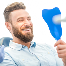 Man looking at white smile in mirror