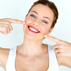 Woman pointing to her smile after direct bonding.