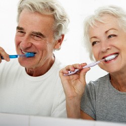 older couple brushing teeth together 