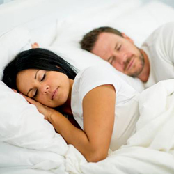 Man and woman sleeping in bed