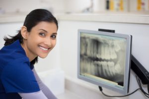 Dental assistant looking at x-ray