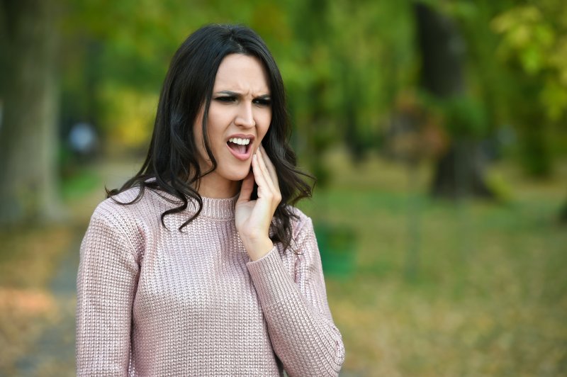 a woman with a dental emergency