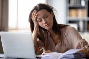 woman who needs sleep apnea treatment in Calimesa falling asleep at her desk 