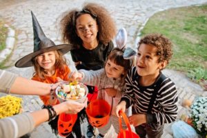 children in Halloween costumes trick or treating