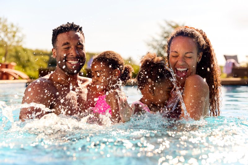 A family swimming in a pool during summer vacation