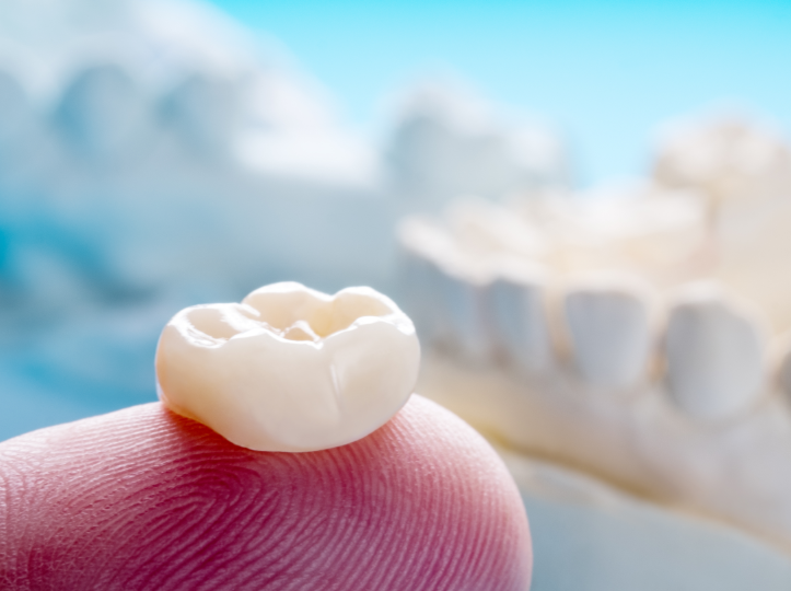 Dental crown on fingertip